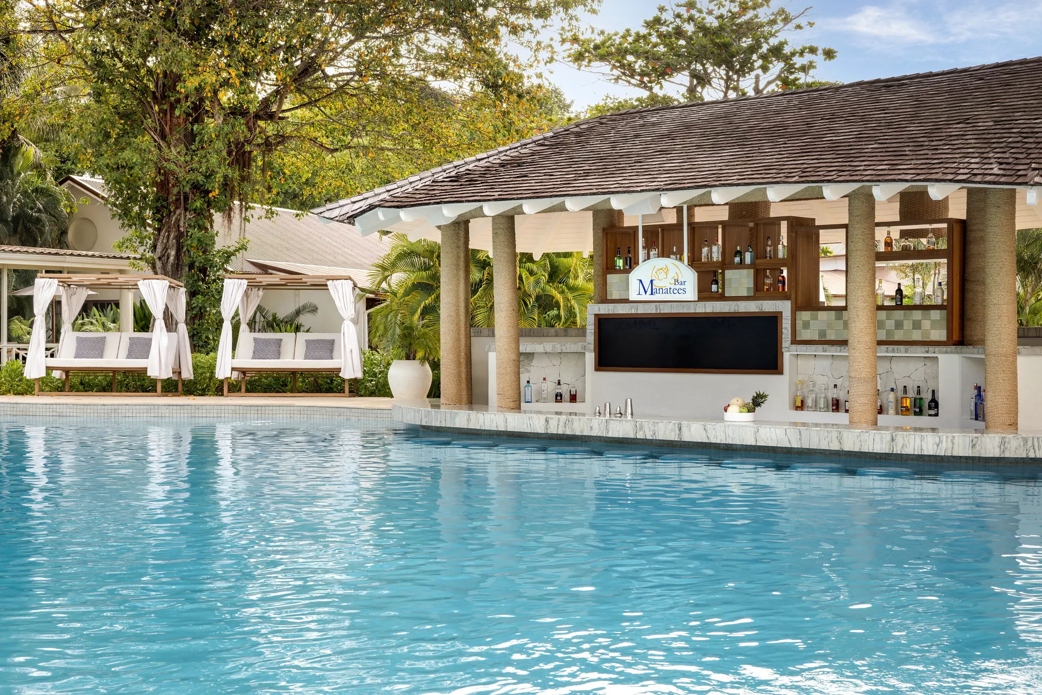 Manatees Swim-Up Bar at Secrets St. Lucia Resort & Spa featuring a lively in-pool bar with tropical cocktails and a relaxed resort atmosphere.